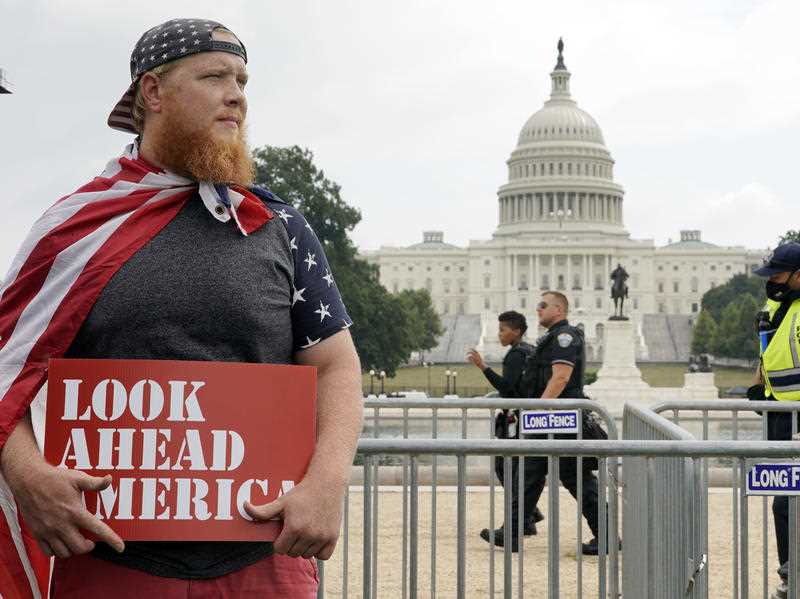 People arrive to attend a rally near the U.S. Capitol in Washington, Saturday, Sept. 18, 2021. The rally was planned by allies of former President Donald Trump and aimed at supporting the so-called 