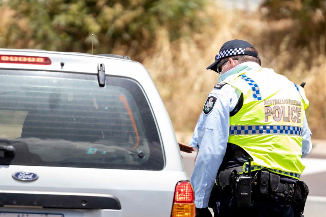 Australian Federal Police officer conducting a traffic stop on a car