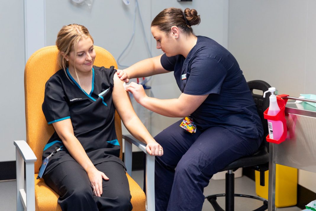 Nurse Maddy Williams received the ACT's first Pfizer vaccine in February. Photo: Kerrie Brewer