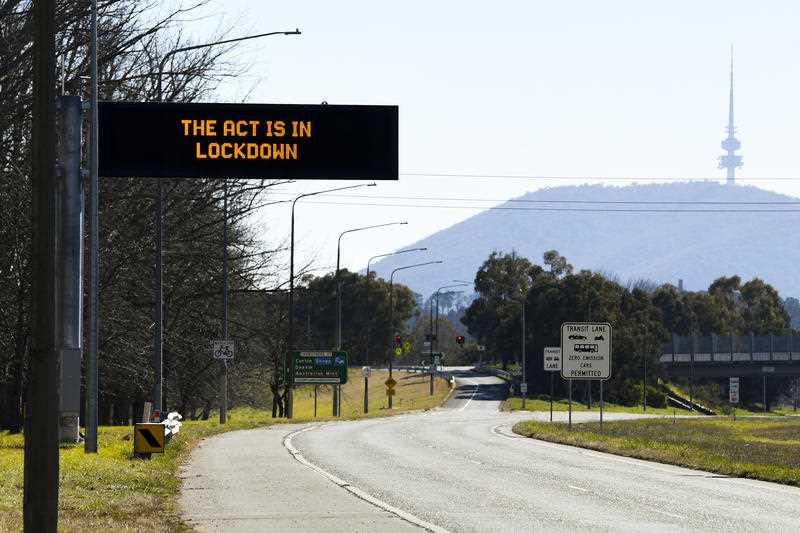 electric message board on roadside in Canberra displaying the message 'The ACT is in lockdown'