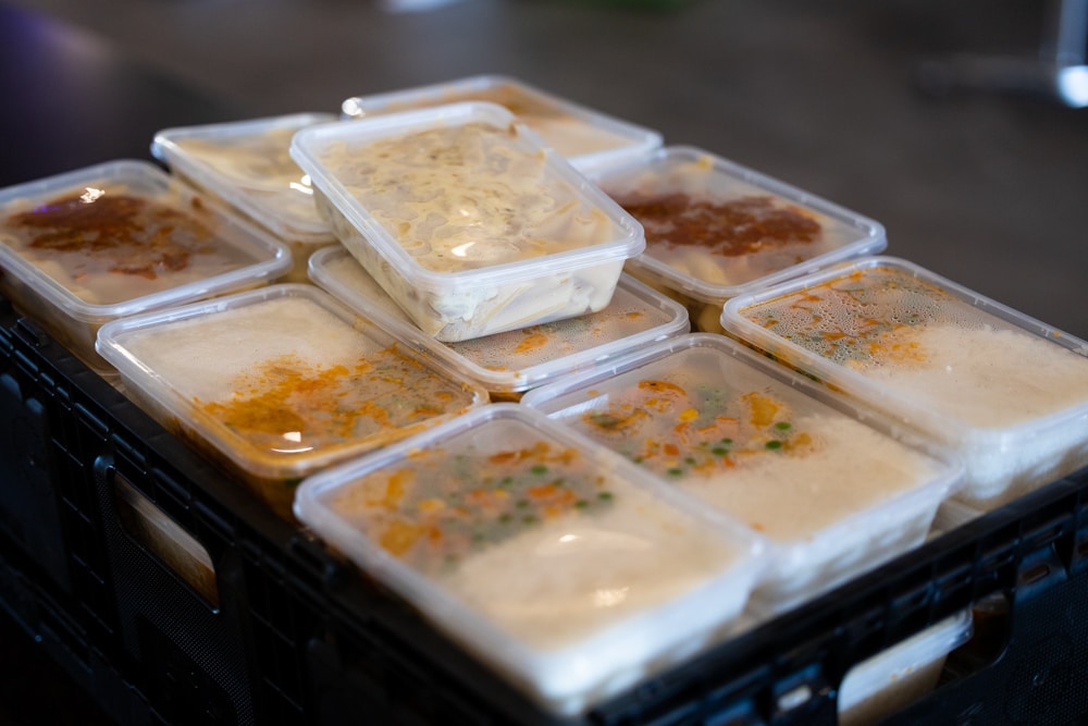 crates of meals in takeaway containers to feed needy Canberrans in lockdown
