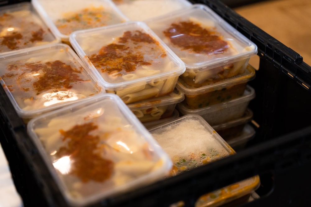 stacks of takeaway containers filled with meals