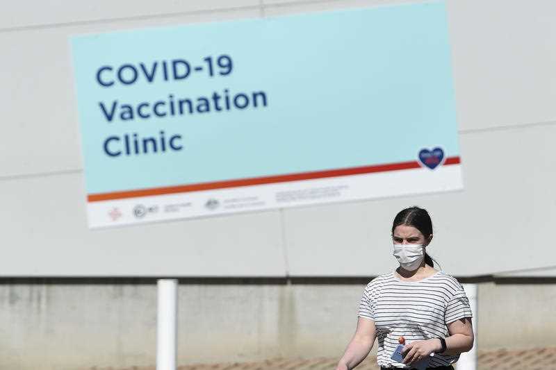 A young woman wearing a face mask is seen at the COVID-19 Vaccination Clinic at the Australian Institute of Sport (AIS) in Canberra, Wednesday, October 6, 2021