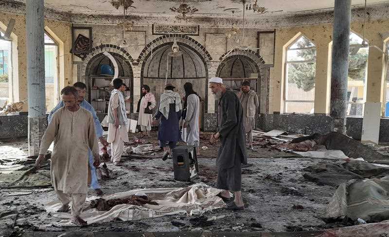 People view the damage inside of a mosque following a bombing in Kunduz, province northern Afghanistan, Friday, Oct. 8, 202