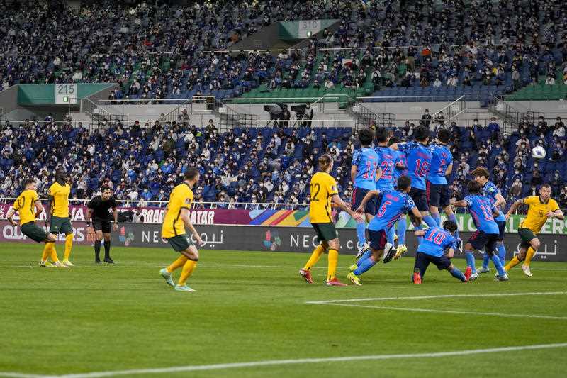 Australia's Ajdin Hrustic, left, scores his team's first goal during the World Cup 2022 group B qualifying soccer match between Australia and Japan at Saitama Stadium in Saitama, north of Tokyo, Tuesday, Oct. 12, 2021.