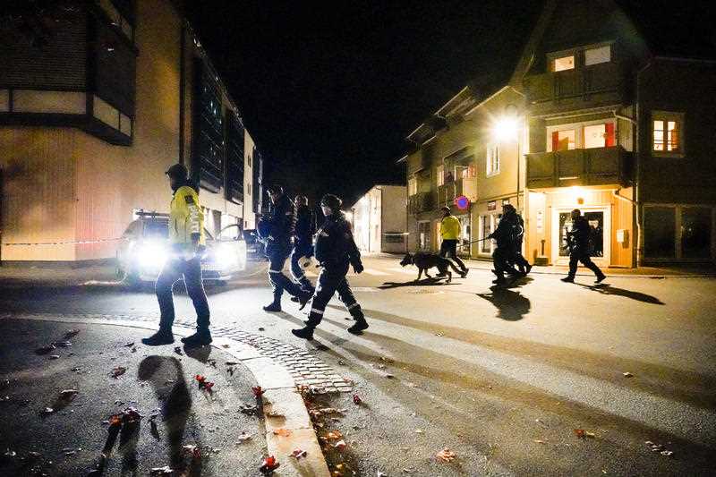 Police walk at the scene after a fatal bow and arrow attack in Kongsberg, Norway, Wednesday, Oct. 13, 2021