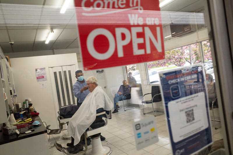 A customer receives a hair cut at Jina’s Hair Dressing in Canberra, Friday, October 15, 2021