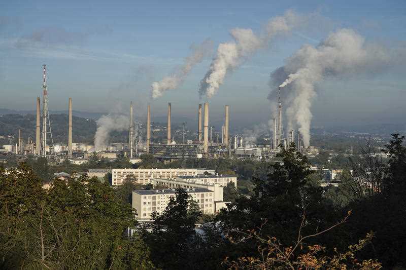 Smoke rises from the Feyzin Total refinery chimneys, outside Lyon, central France, Friday, Oct. 15, 2021