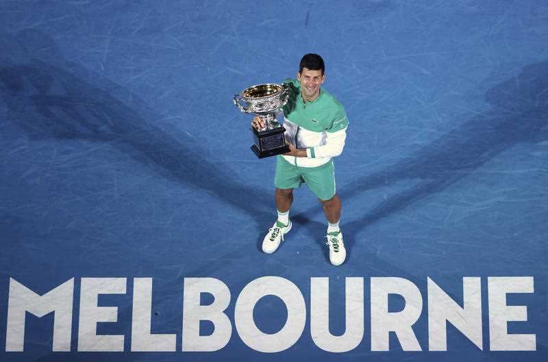 Serbia's Novak Djokovic holds the Norman Brookes Challenge Cup after defeating Russia's Daniil Medvedev in the men's singles final at the Australian Open tennis championship in Melbourne, Australia in February 2021