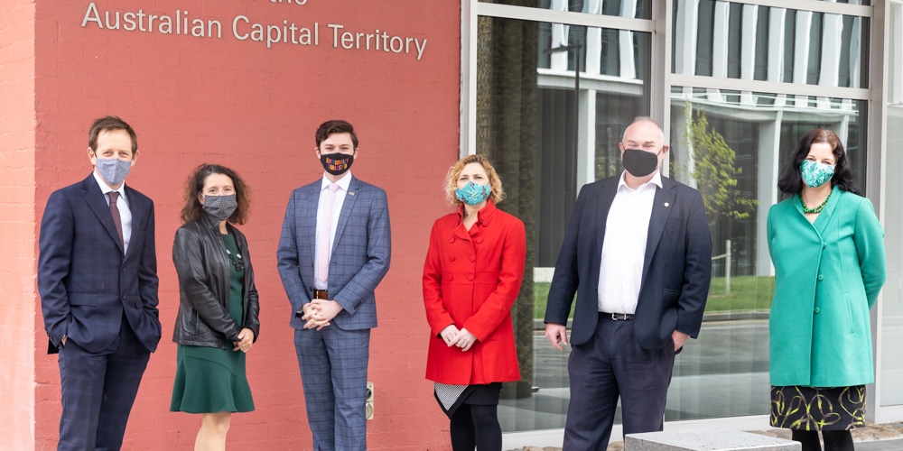 3 female and 3 male politicians standing outside the ACT Legislative Assembly in Canberra