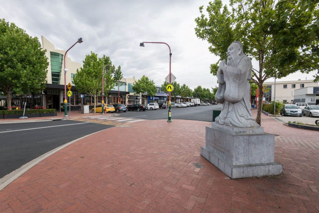 Dickson shopping precinct in Canberra with statue of Confucius at entry to China Town