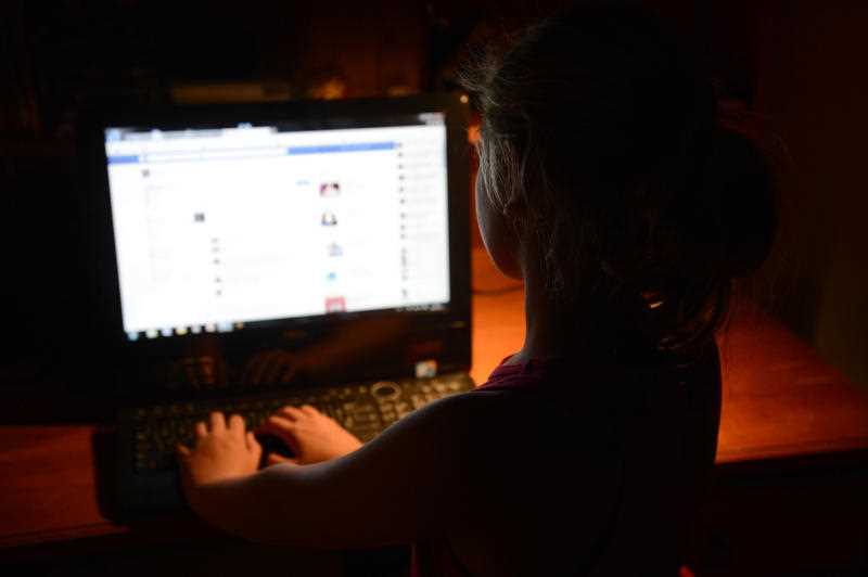A young girl uses a personal computer