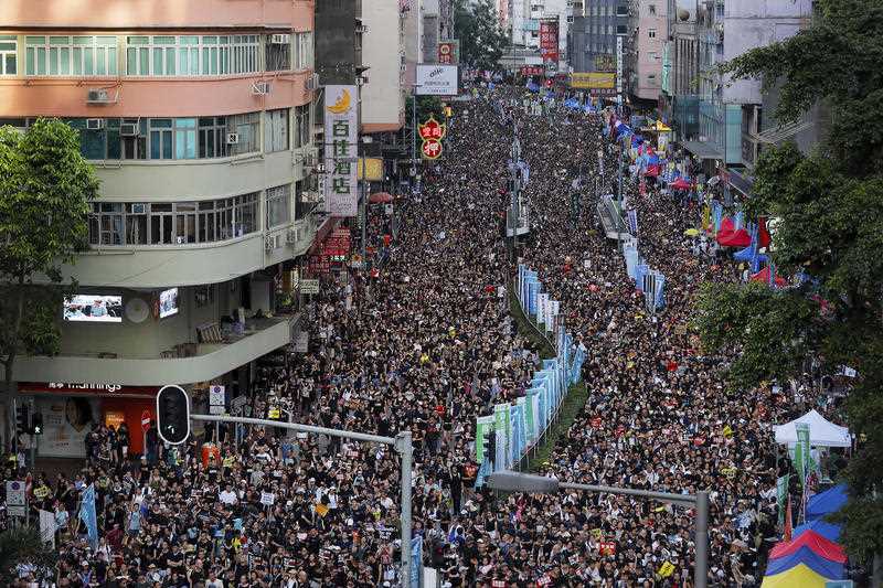 In this 1 July 2019 file photo, protesters flood the streets as they take part in an annual rally in Hong Kong.