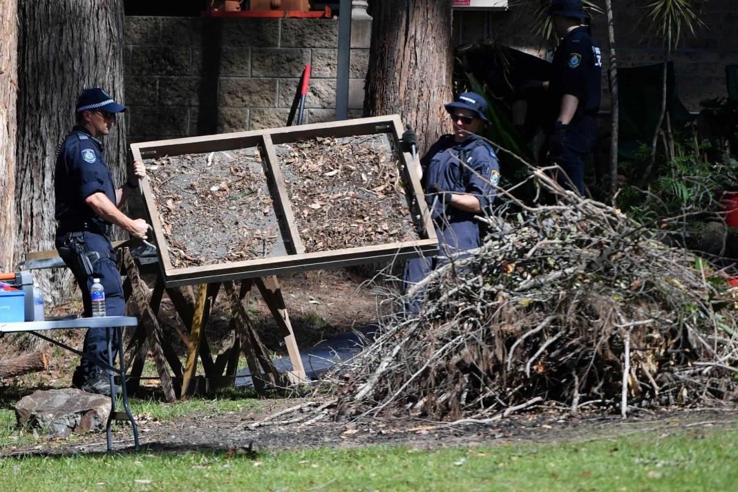 Police officers sifting debris at a house in Kendall, NSW where three-year-old William Tyrrell disappeared.