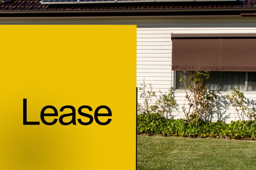 Yellow 'lease' sign outside weatherboard house