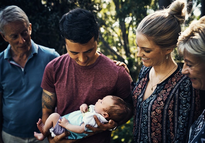 Shot of a young couple introducing their newborn baby son to his grandparents