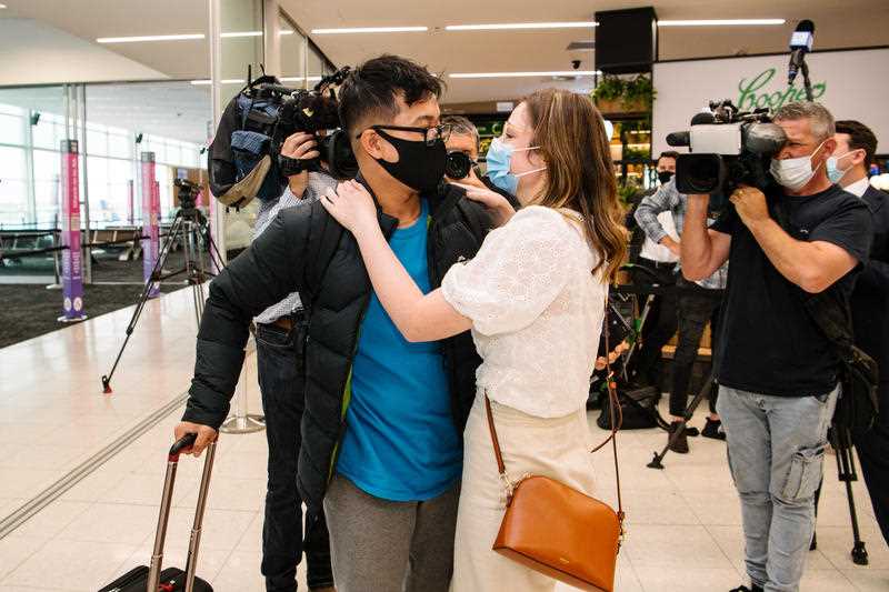 Young couple Hung Nguyen and Isabella Hill are reunited after a year after a flight from Sydney arrives this morning in Adelaide, Tuesday, November 23, 2021.