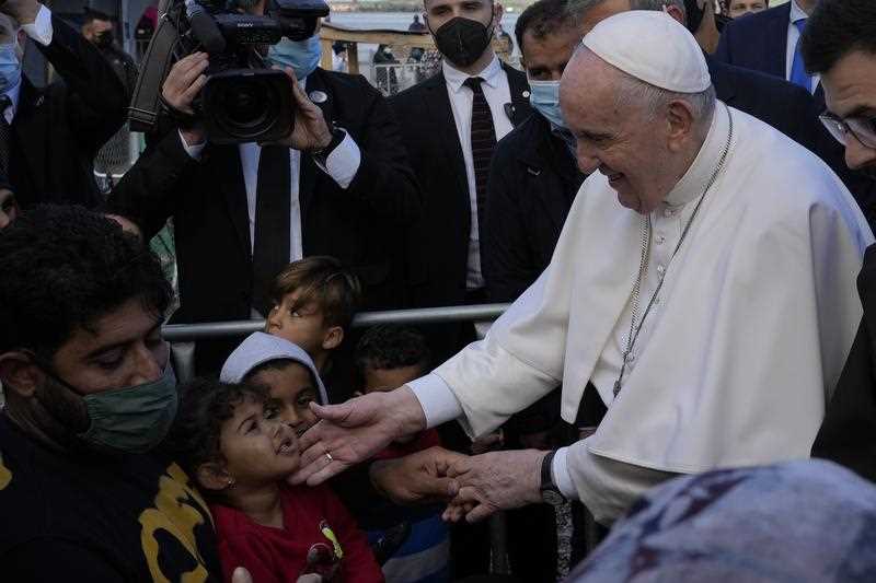 Pope Francis meets migrants during his visit at the Karatepe refugee camp, on the northeastern Aegean island of Lesbos, Greece, Sunday, Dec. 5, 2021