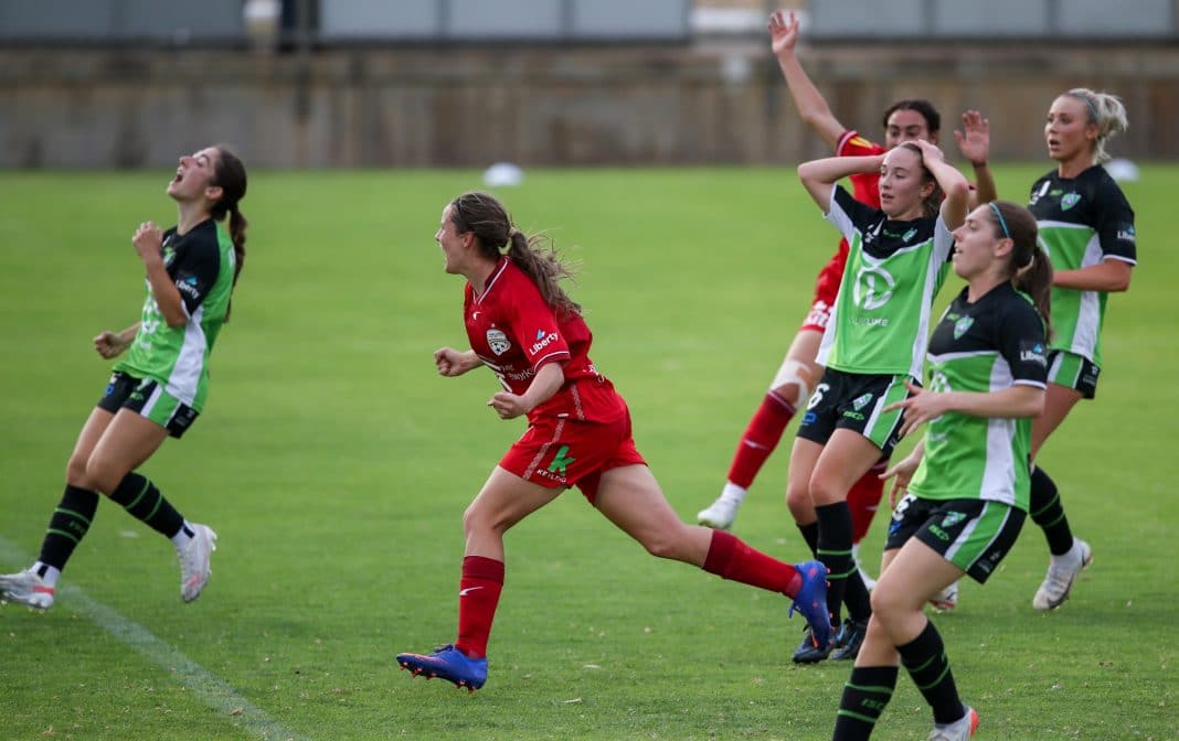 female soccer players in the A-League Women's match between Canberra United in green and Adelaide united in red