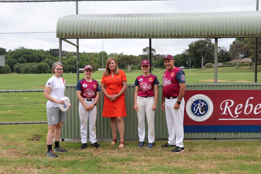 Yvette Berry, ACT Minister for Sport and Recreation, with members of the Rebels Baseball Club and Canberra Ultimate. Photo provided.