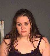 headshot of brunette woman wanted by police for stabbing and theft