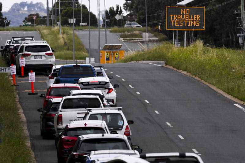 A sign reads “No Traveller Testing’ as cars line up near a Drive Through COVID-19 testing site in the suburb of Mitchell in Canberra, Monday, December 27, 2021.