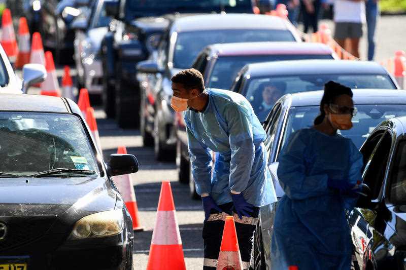 Members of the public queue in their cars for a COVID-19 PCR test at the Rose Bay Drive-through Laverty Pathology clinic, in Sydney, Thursday, December 30, 2021.