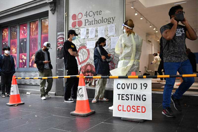 People queue at a walk-in COVID-19 testing site at in Melbourne, Wednesday, January 5, 2022.