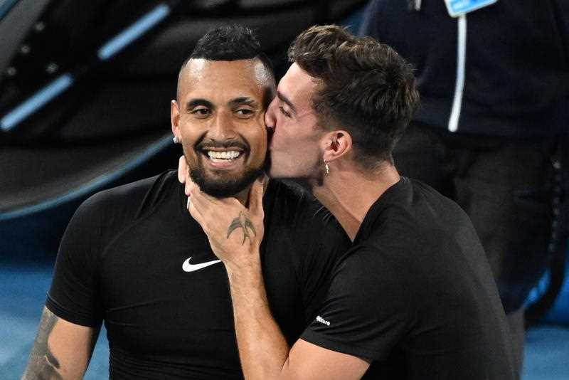 Nick Kyrgios (left) is kissed by Thanasi Kokkinakis after winning the Men’s doubles final against Matthew Ebden and Max Purcell of Australia on Day 13 of the Australian Open, at Melbourne Park
