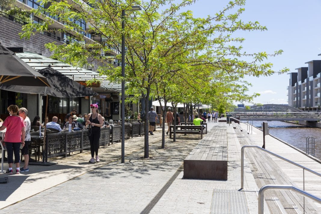 people are seen dining outdoors or walking along Kingston Foreshore precinct in Canberra