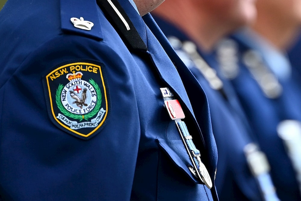 NSW Police badge is seen on an officer's uniform
