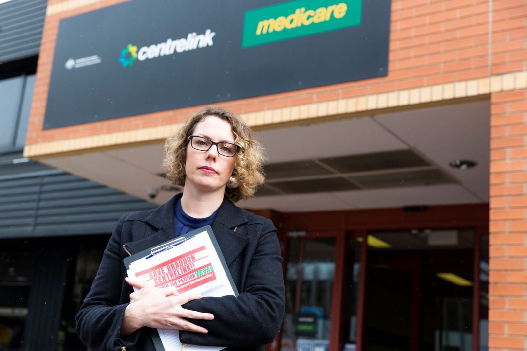 Federal Labor Member for Canberra Alicia Payne is seen holding a petition to save the Braddon Centrelink office outside the shopfront