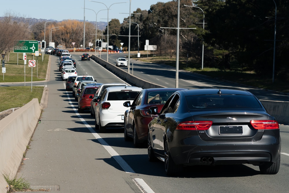 long queue of cars with people waiting to be tested for covid in the ACT