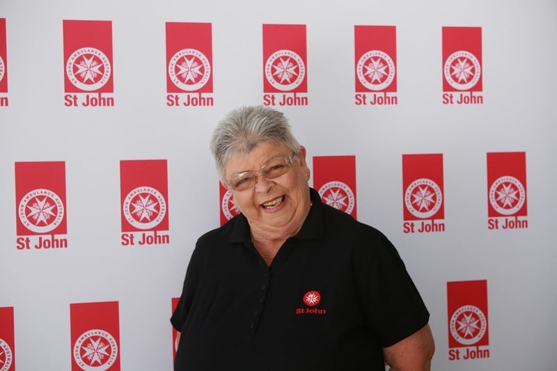 smiling elderly woman in St John's Ambulance shirt