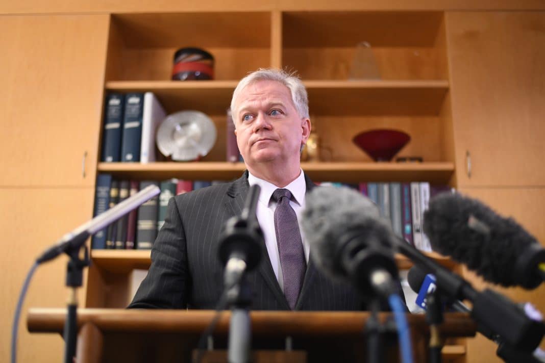 ANU vice chancellor Professor Brian Schmidt is seen speaking into multiple microphones at a press conference