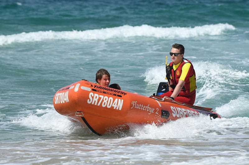 Volunteer Surf Life savers perform a rescue drill at the Surf Life Saving season launch in September 2018