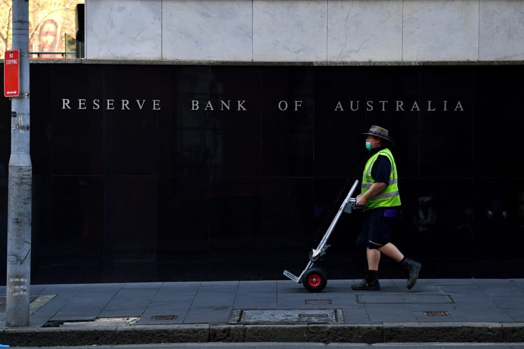 A pedestrian walks past the Reserve Bank of Australia head office in Sydney