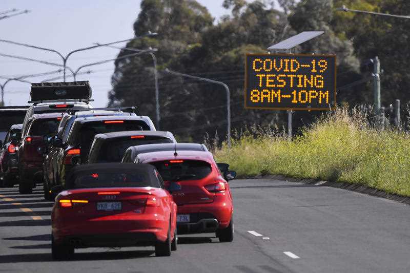 Cars line up near a Drive Through COVID-19 testing site in the suburb of Mitchell in Canberra, Wednesday, December 22, 2021.