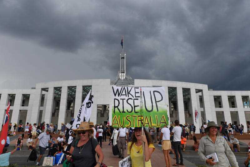 Demonstrators protesting for freedom gather outside Parliament House in Canberra, Monday, January 31, 2022.