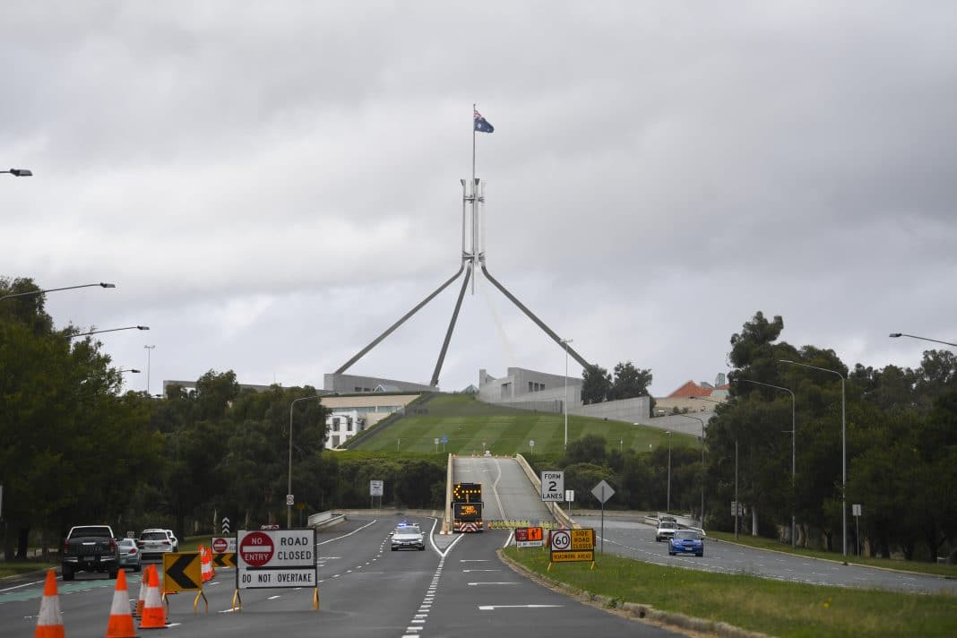 Access ramp towards the Australian Parliament is blocked off while Police move on protesters from a makeshift camp next to the National Library in Canberra, Friday, February 4, 2022.