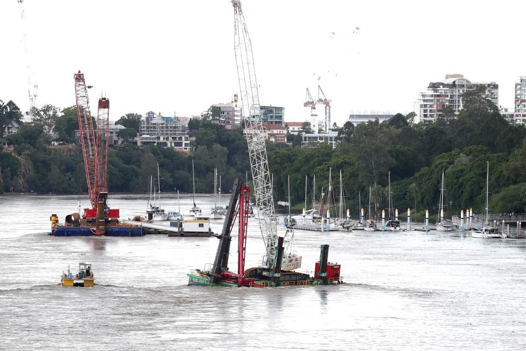 A floating crane comes loose near Eagle Street Pier, in Brisbane River during deadly flooding in South East Queensland