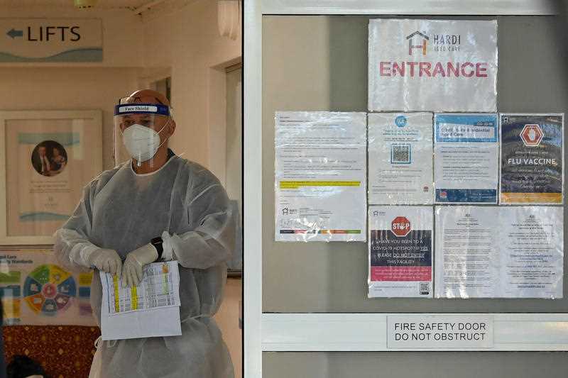 An aged care worker wearing PPE is seen inside a nursing home in lockdown