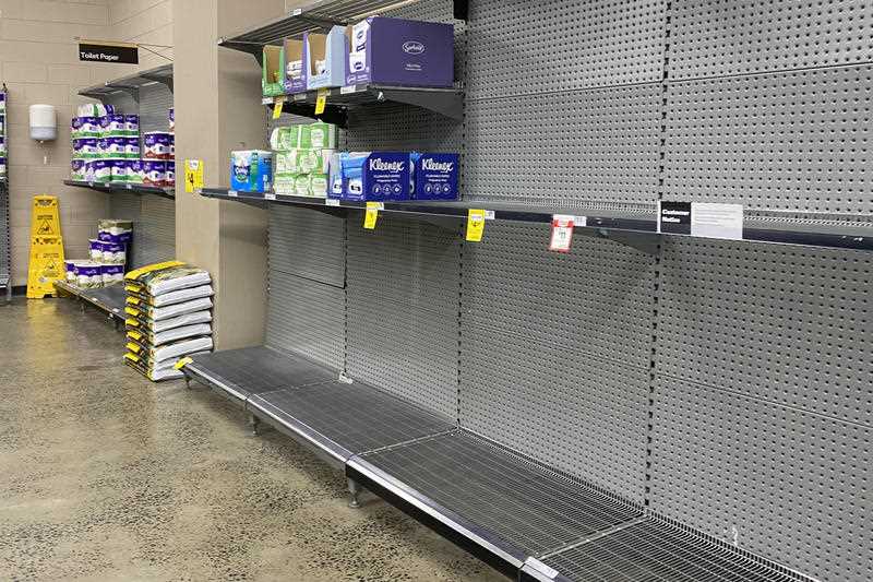 Empty shelves of toilet paper are seen at a supermarket