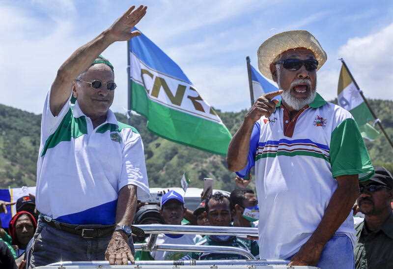 East Timor presidential candidate and former president Jose Ramos Horta (L) from the National Congress for Timorese Reconstruction (Conselho Nacional de Reconstrucao de Timor, CNRT) party, accompanied by former president Xanana Gusmao