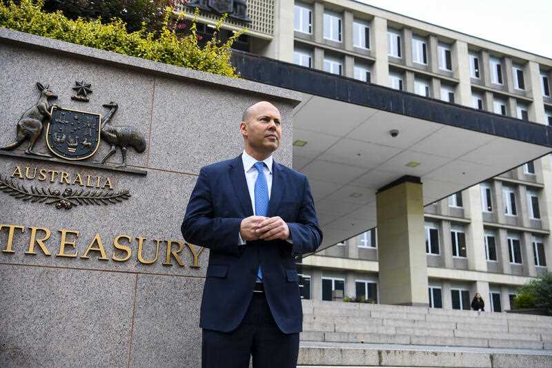 Australian Treasurer Josh Frydenberg poses for photograph outside the Treasury Department building in Canberra, Thursday, March 24, 2022.