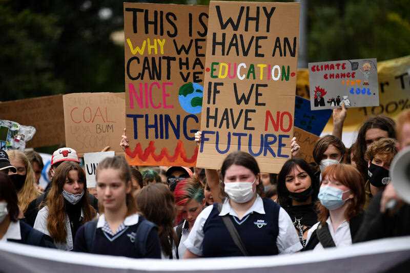 School students hold placards during a Climate School Strike protest