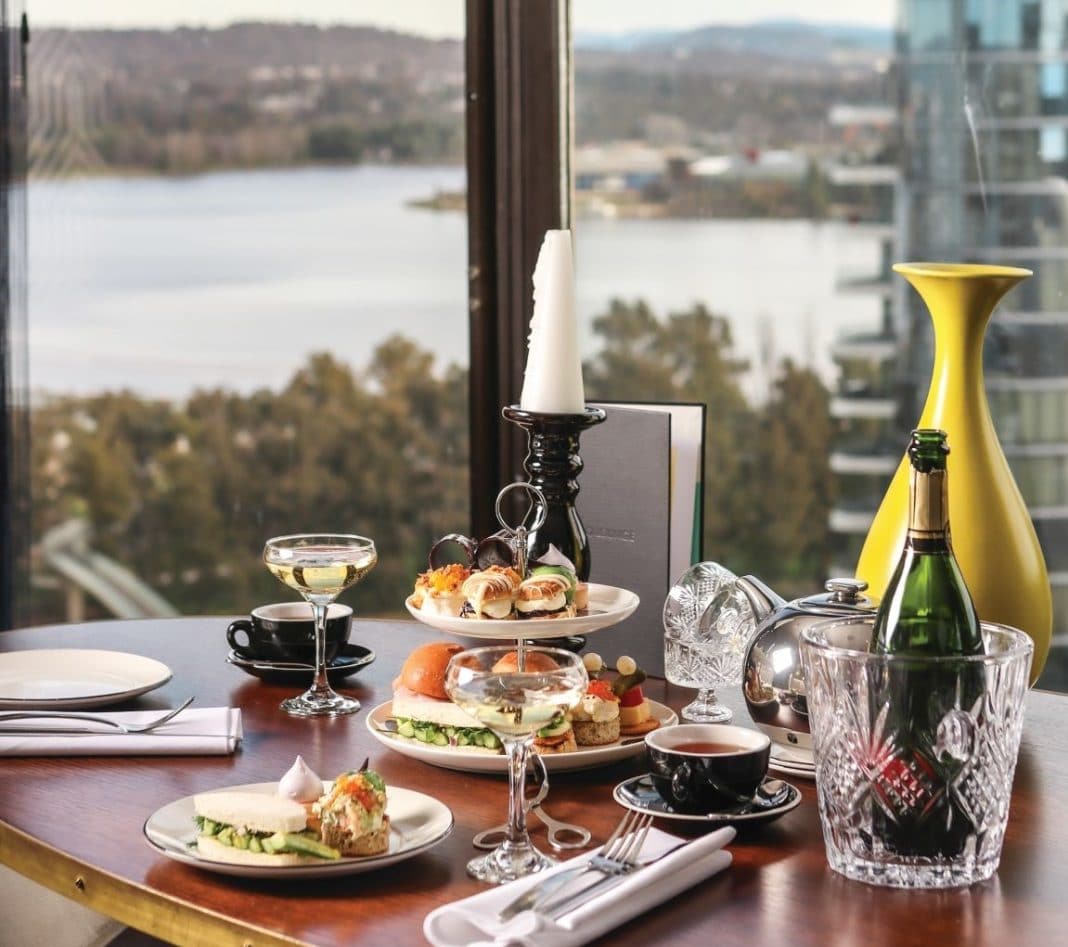 high tea and champagne on a table overlooking Lake Burley Griffin in Canberra