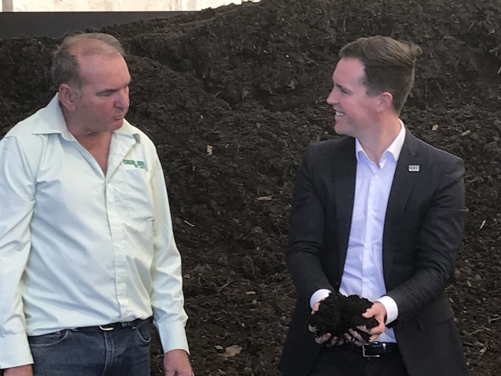 Chris Steel (right), ACT Minister for City Services, and Phil Corkhill, from Corkhill Bros., discuss compost. Photo: Nicholas Fuller