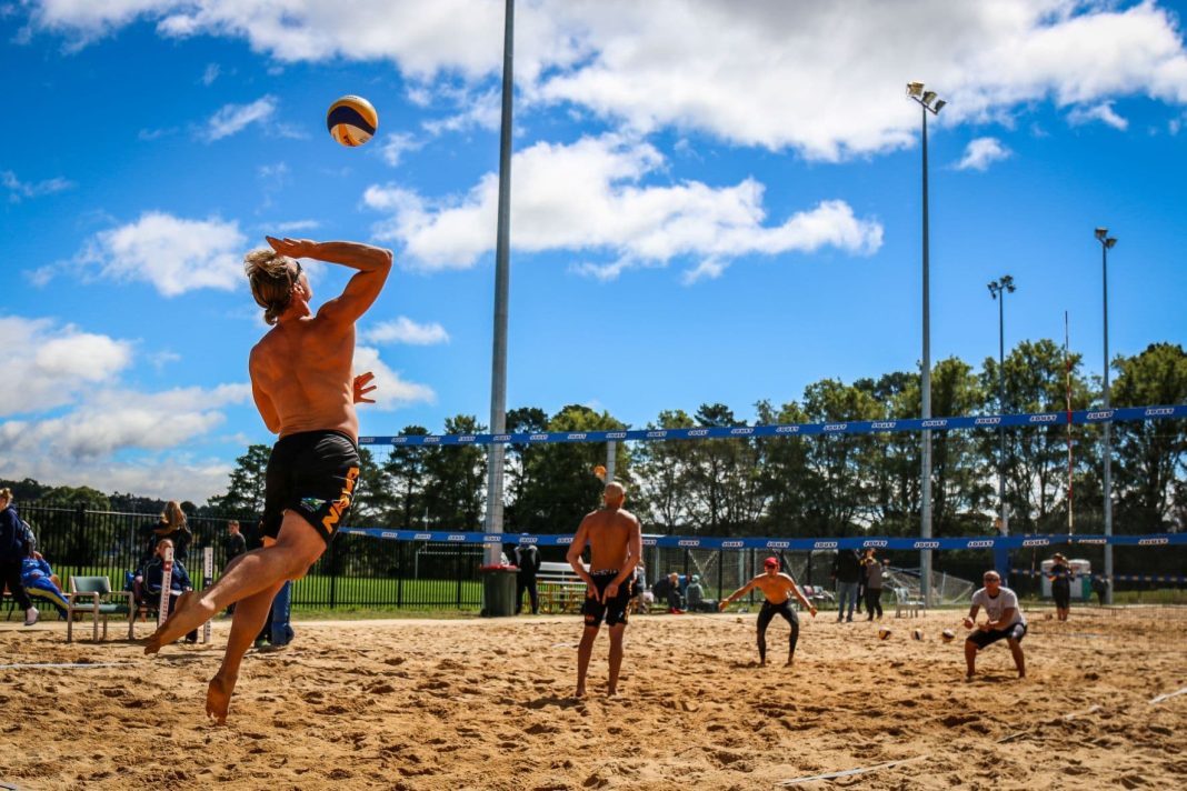four men playing professional beach volleyball at the Lyneham Beach Sports centre in Canberra