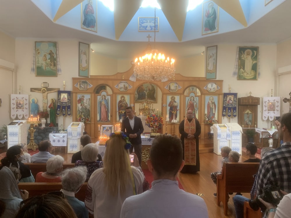 man and male priest addressing congregation at Ukrainian Orthodox Church in Canberra